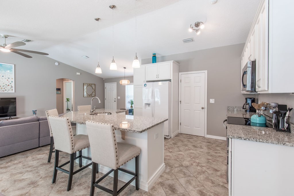 3673 2nd Place Southwest Vero Beach, FL 32968 - Photo 25 of 33 a large kitchen with a table and chairs
