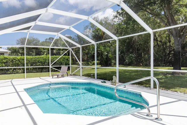 a view of a backyard with floor to ceiling windows