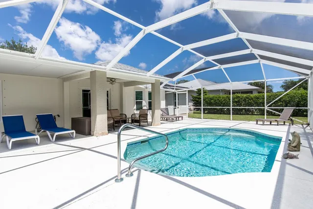 a view of a house with backyard sitting area and porch