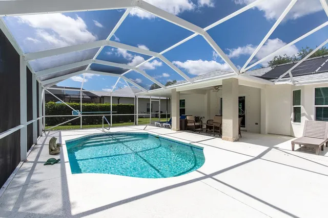 a view of a house with a backyard porch and sitting area