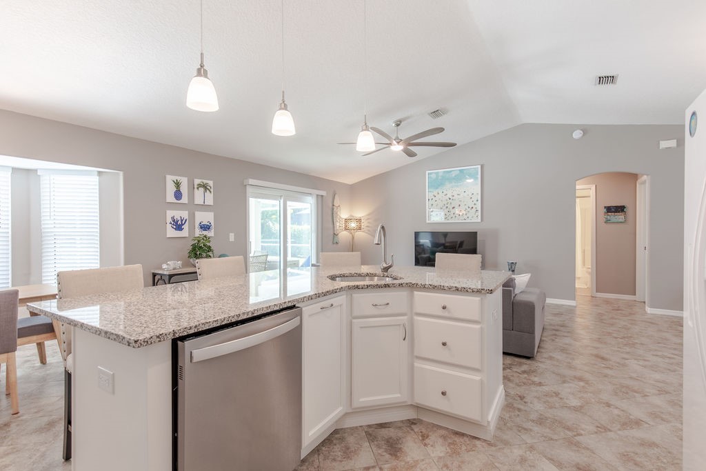 3673 2nd Place Southwest Vero Beach, FL 32968 - Photo 8 of 33 a kitchen with white cabinets and sink