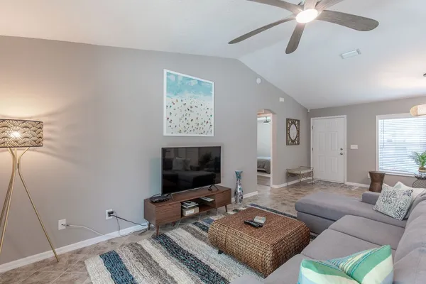 a living room with furniture and a flat screen tv