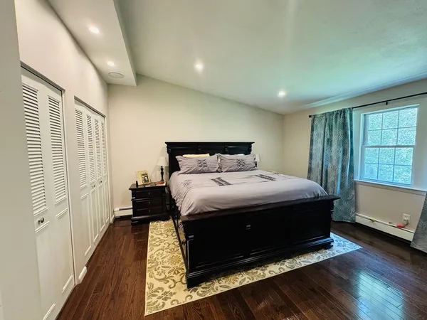 a bedroom with a bed and a window