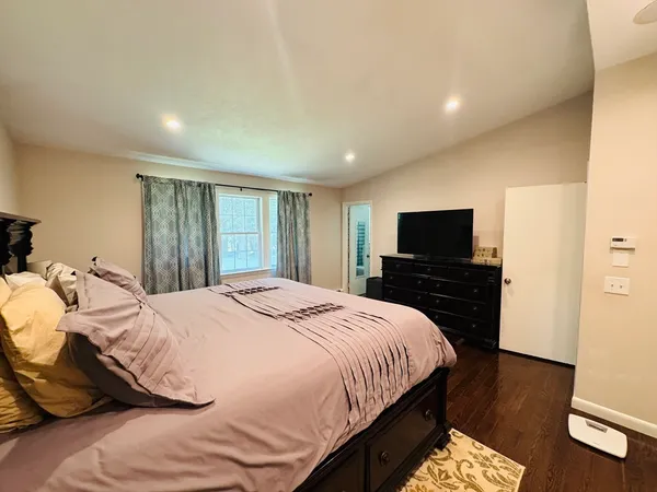 a bedroom with a bed and a television
