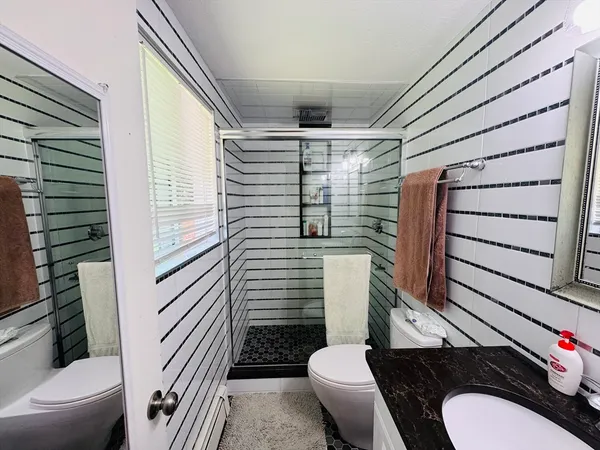 a bathroom with a toilet and a shower