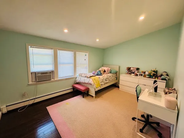 a bedroom with furniture and a window
