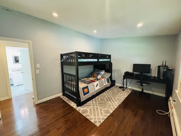 a bedroom with furniture and a wooden floor
