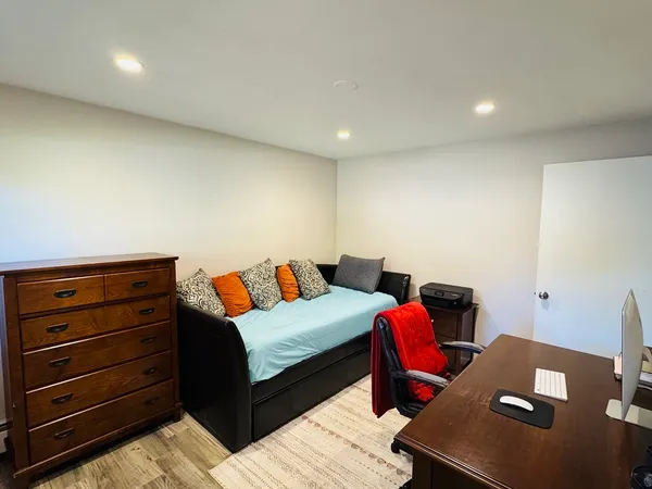 a bedroom with a bed and a desk