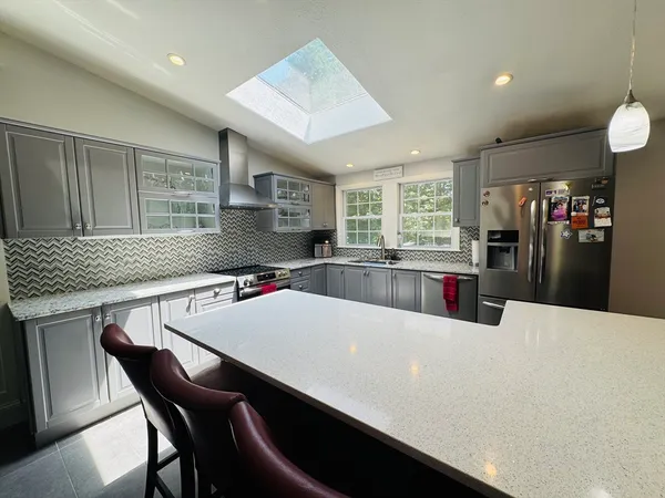 a large kitchen with a table and chairs