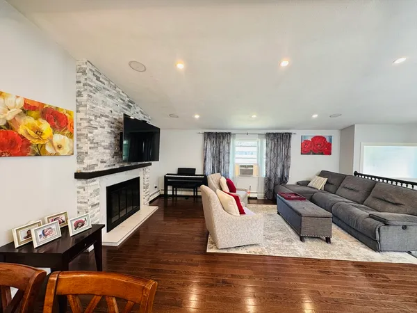 a living room with furniture flat screen tv and a fireplace