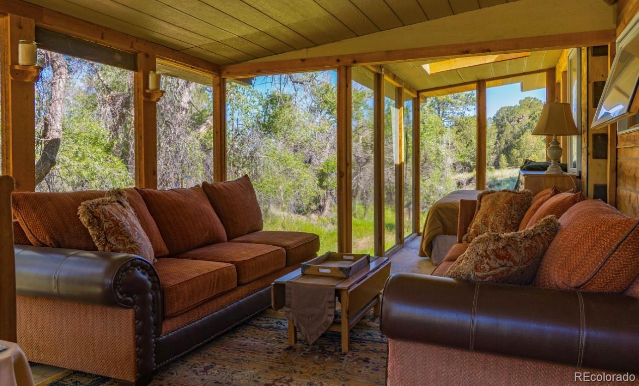 525 Brush Hollow Road Westcliffe, CO 81252 - Photo 19 of 21 a living room with furniture and a large window