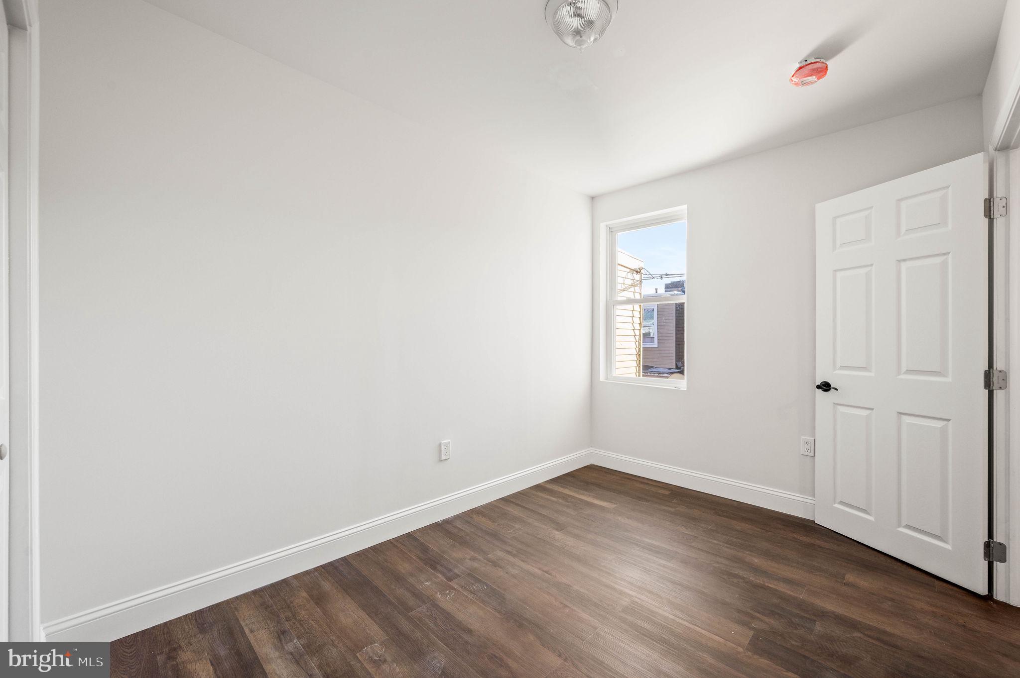 1852 East Lippincott Street Philadelphia, PA 19134 - Photo 16 of 25 an empty room with wooden floor and windows