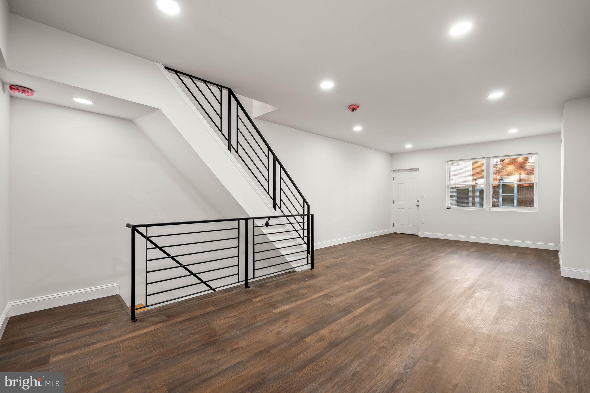 1852 East Lippincott Street Philadelphia, PA 19134 - Photo 20 of 25 a view of an empty room with wooden floor and stairs