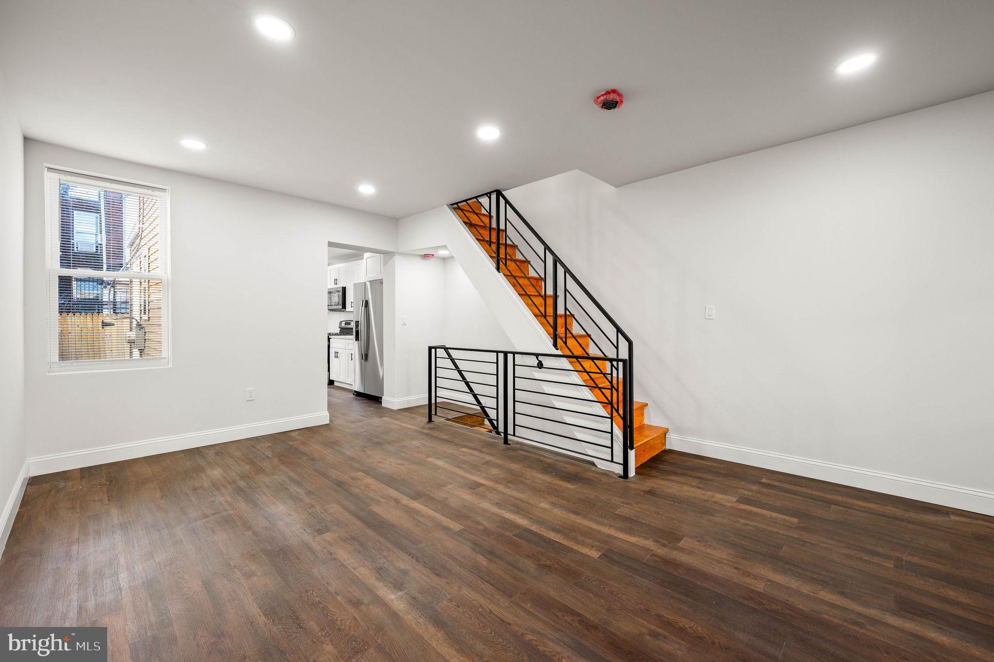 1852 East Lippincott Street Philadelphia, PA 19134 - Photo 22 of 25 an empty room with wooden floor stairs and windows