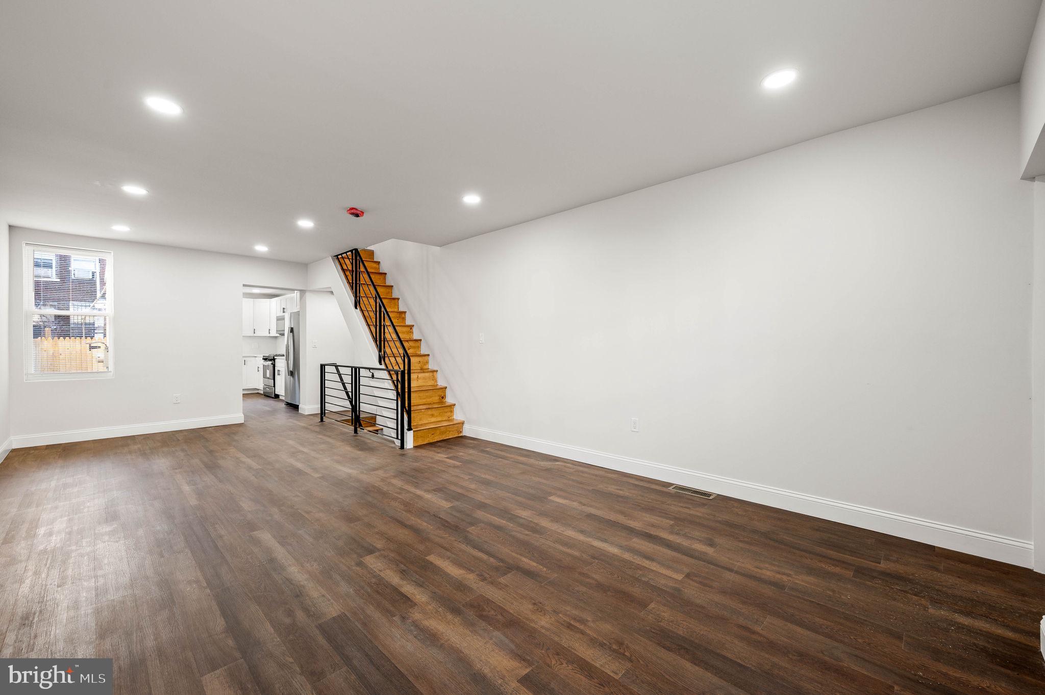1852 East Lippincott Street Philadelphia, PA 19134 - Photo 23 of 25 an empty room with wooden floor and stairs