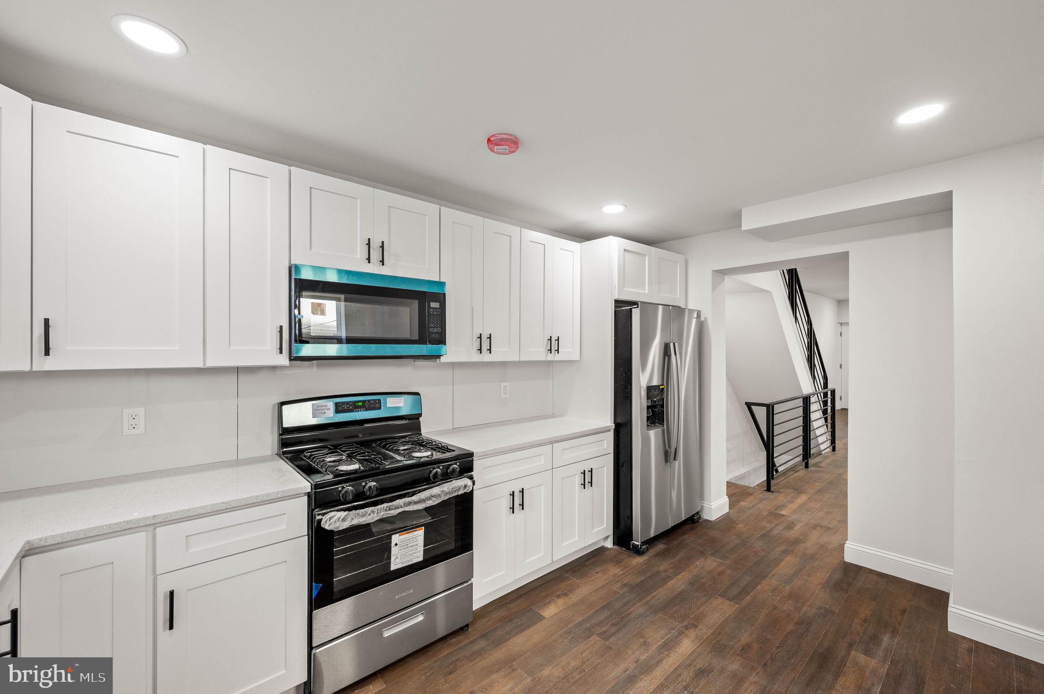 1852 East Lippincott Street Philadelphia, PA 19134 - Photo 4 of 25 a kitchen with stainless steel appliances a refrigerator stove and microwave