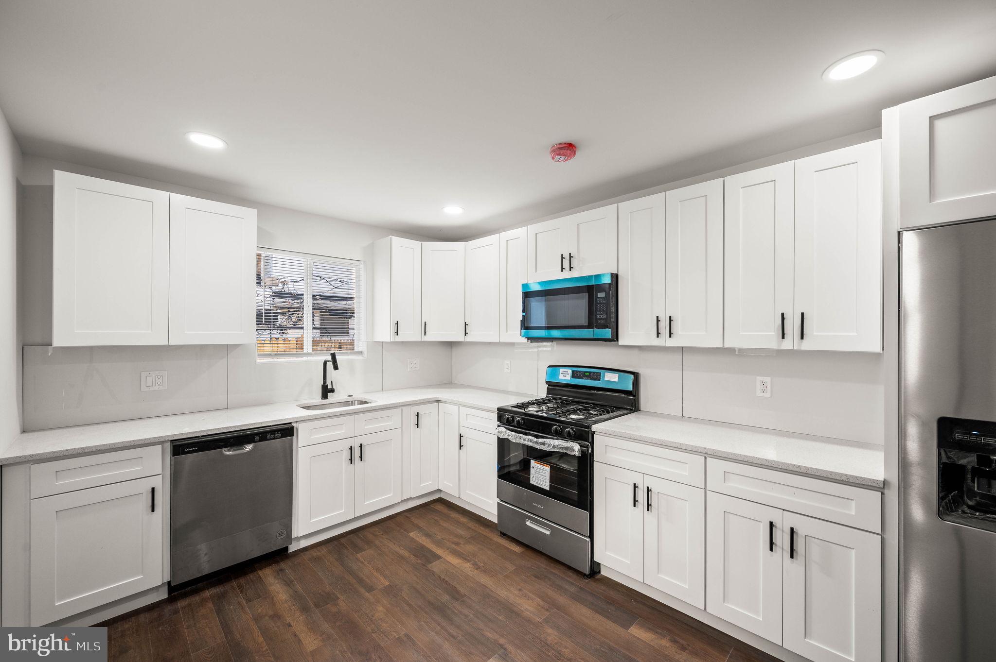 1852 East Lippincott Street Philadelphia, PA 19134 - Photo 5 of 25 a kitchen with white cabinets and white appliances