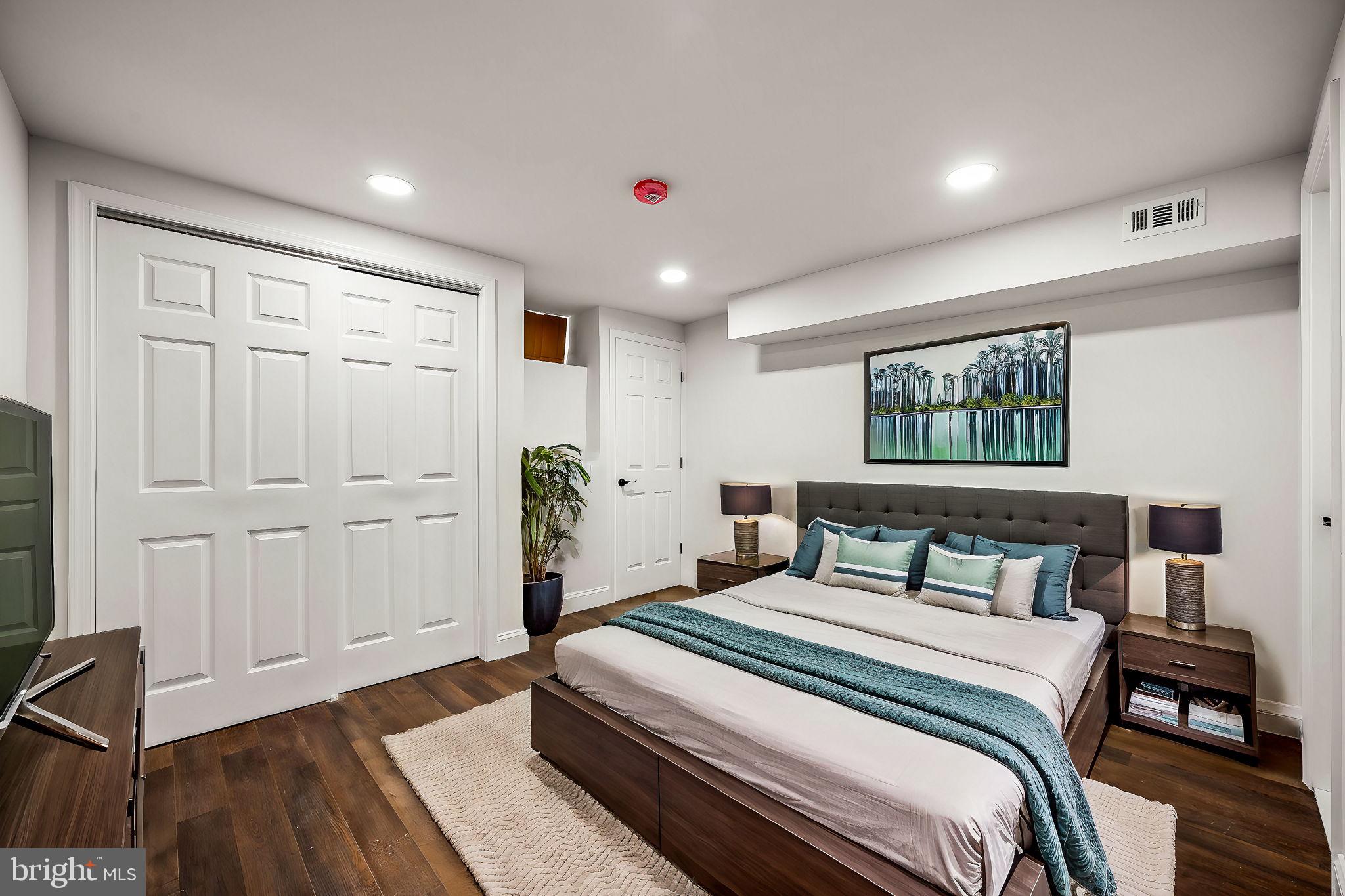1852 East Lippincott Street Philadelphia, PA 19134 - Photo 6 of 25 a bedroom with a large bed and a chandelier
