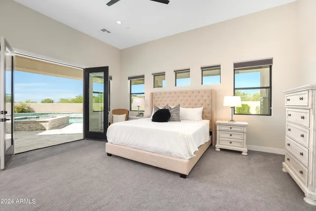 a bedroom with a large bed and a view of bedroom
