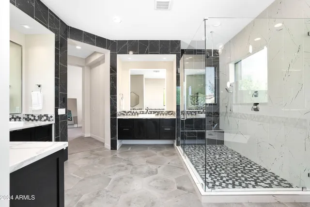 a bathroom with a glass shower door and a sink