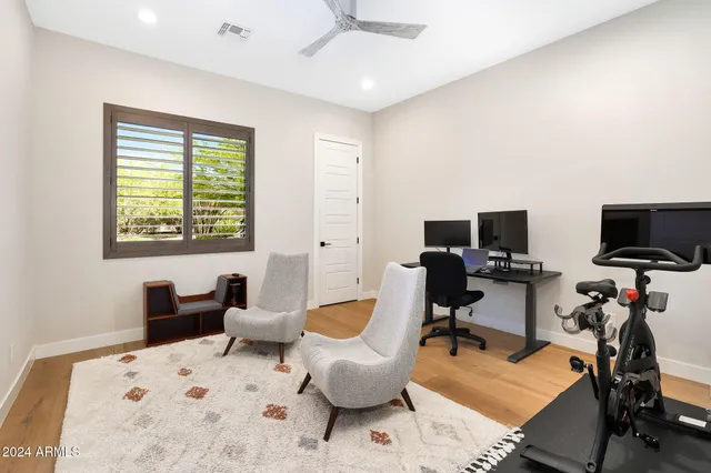a view of a workspace with furniture and a bedroom