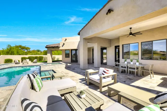 a view of a patio with dining table and chairs with wooden floor
