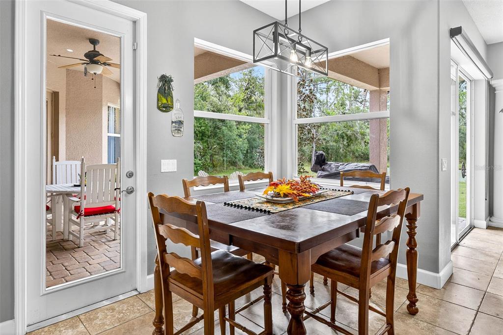 13887 Gavin Road Dover, FL 33527 - Photo 22 of 74 a view of a dining room and livingroom with furniture wooden floor and a chandelier