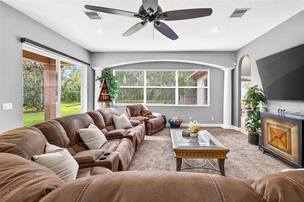 13887 Gavin Road Dover, FL 33527 - Photo 24 of 74 a living room with furniture a large window and a flat screen tv