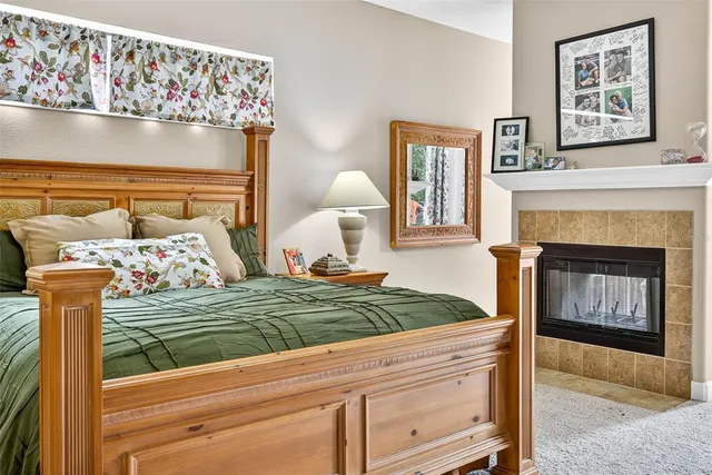 a bedroom with a bed potted plant with the wooden floor