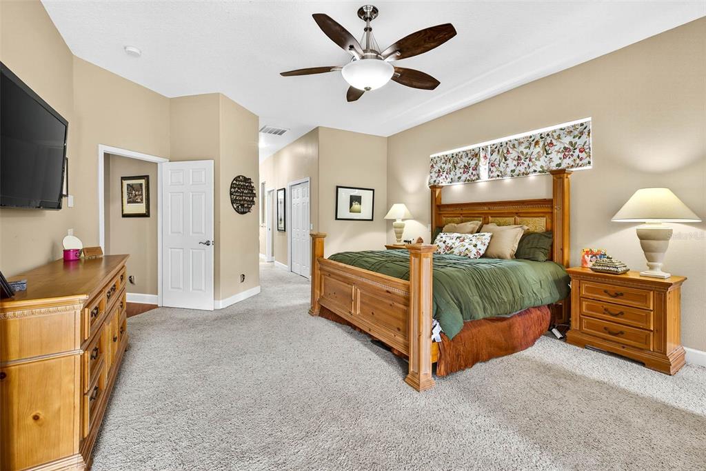 13887 Gavin Road Dover, FL 33527 - Photo 33 of 74 a bedroom with a bed and a flat screen tv