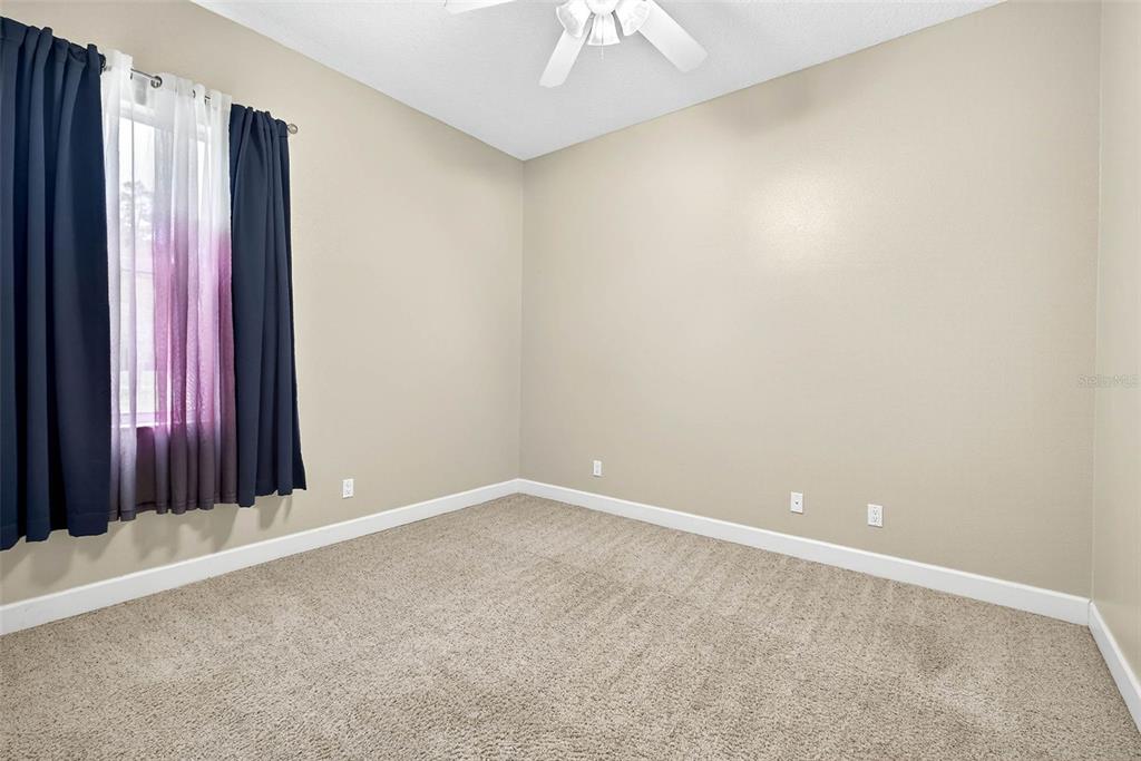 13887 Gavin Road Dover, FL 33527 - Photo 44 of 74 an empty room with a window and a chandelier fan