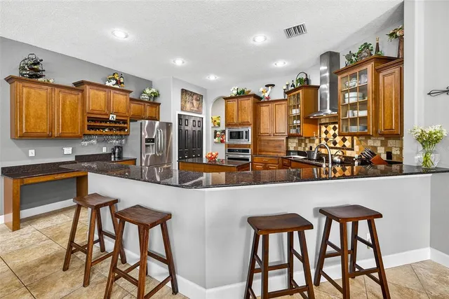 a kitchen with granite countertop a sink and a counter top space