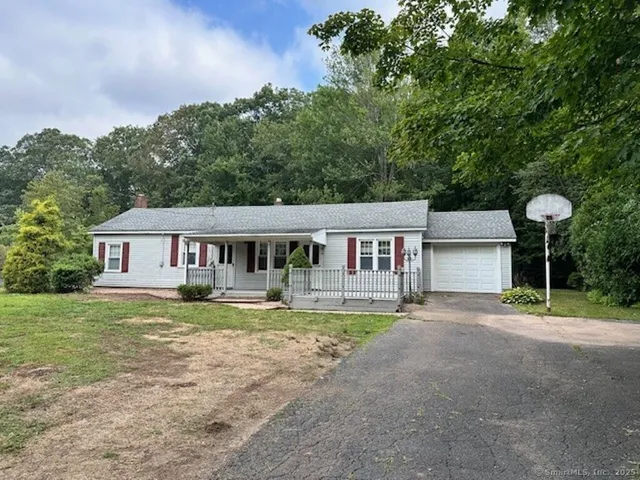 a house that has a big yard and large trees
