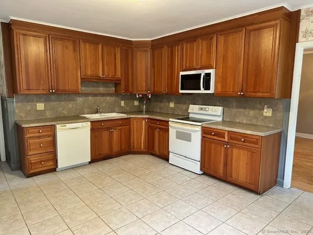 a kitchen with stainless steel appliances granite countertop a stove sink and cabinets