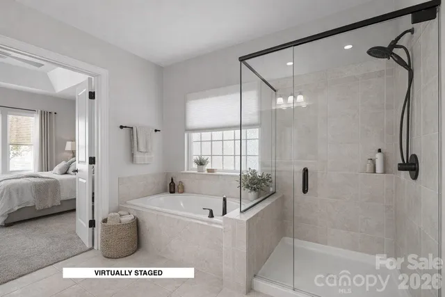 a bathroom with a tub shower and toilet