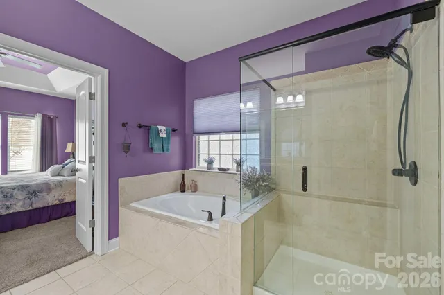 a bathroom with a tub sink and shower