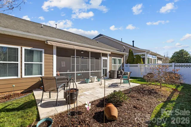a house view with a sitting space and garden