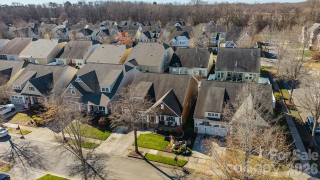 an aerial view of a houses with yard