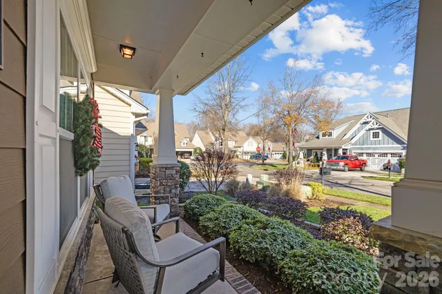 a balcony view with two chairs and a potted plant