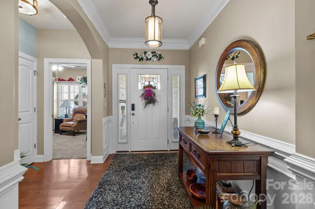 a view of a livingroom with furniture cabinet and a chandelier
