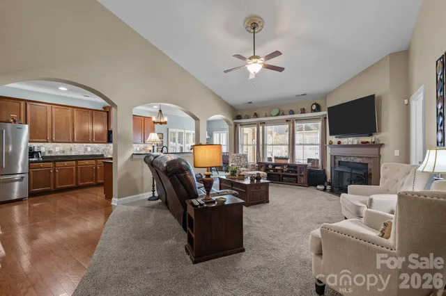 a living room with fireplace furniture and a flat screen tv