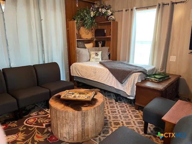 a bedroom with furniture and a window