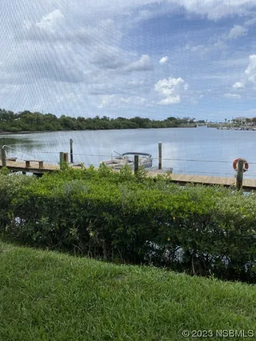 a view of a lake with houses in background