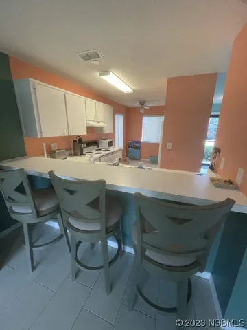 a kitchen with a sink cabinets and window