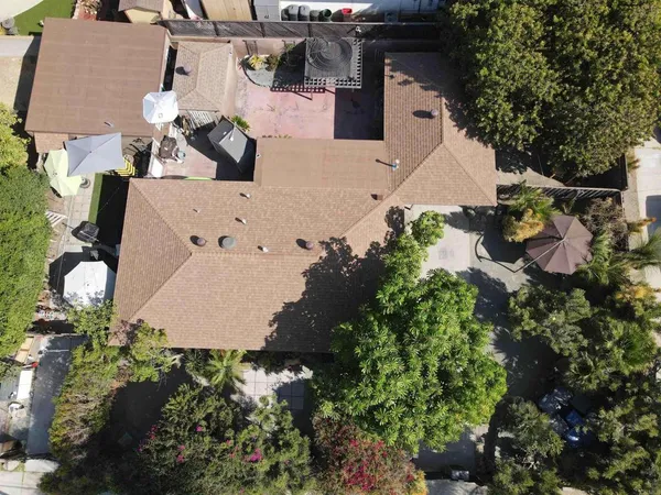 an aerial view of multiple houses with yard