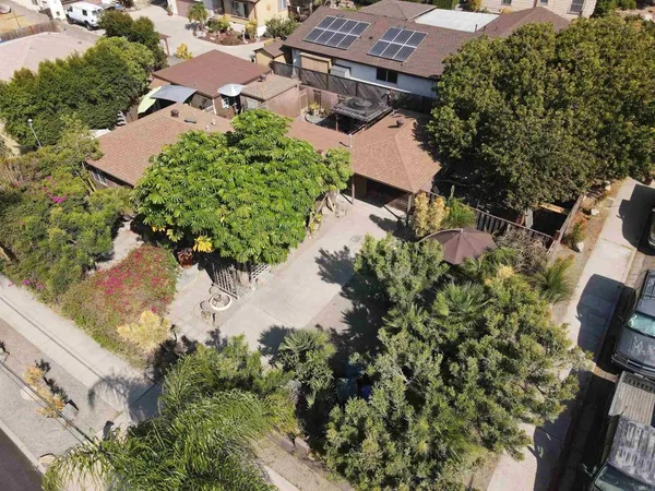 an aerial view of a house with a yard and lake view