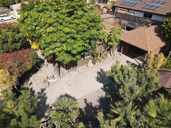 an aerial view of a house with a yard