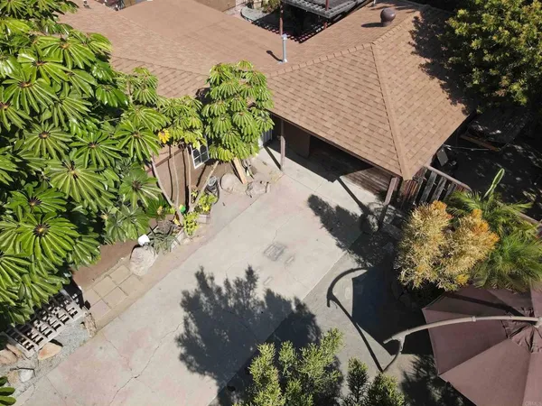 an aerial view of a house with a yard basket ball court and outdoor seating