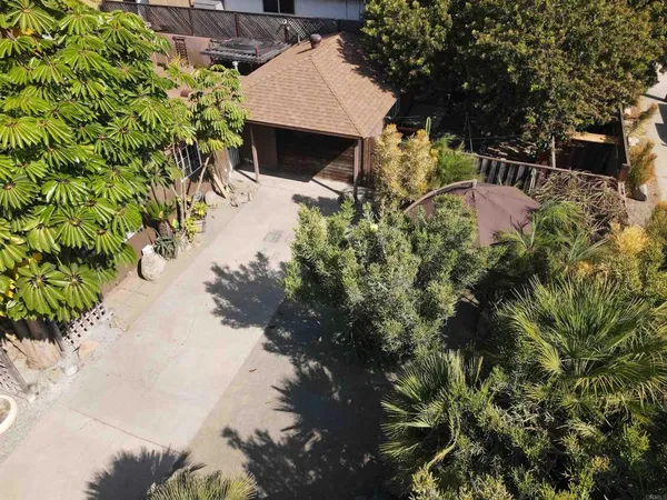 a backyard of a house with table and chairs