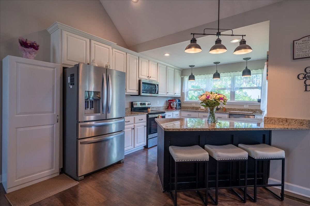 460 Ables Lane Pulaski, TN 38478 - Photo 9 of 23 a kitchen with stainless steel appliances a dining table chairs refrigerator and microwave